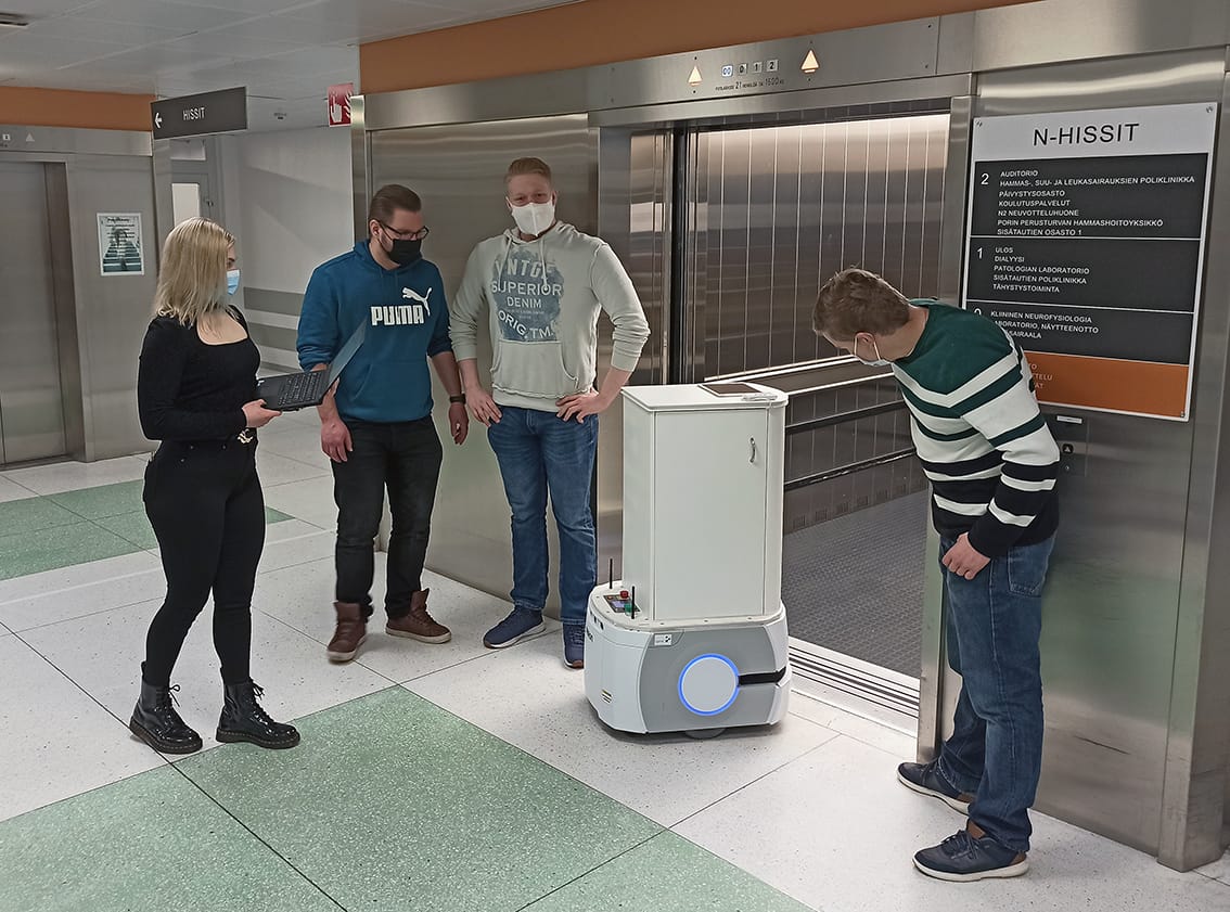 In the picture students use manual control to get the mobile robot into the lift.