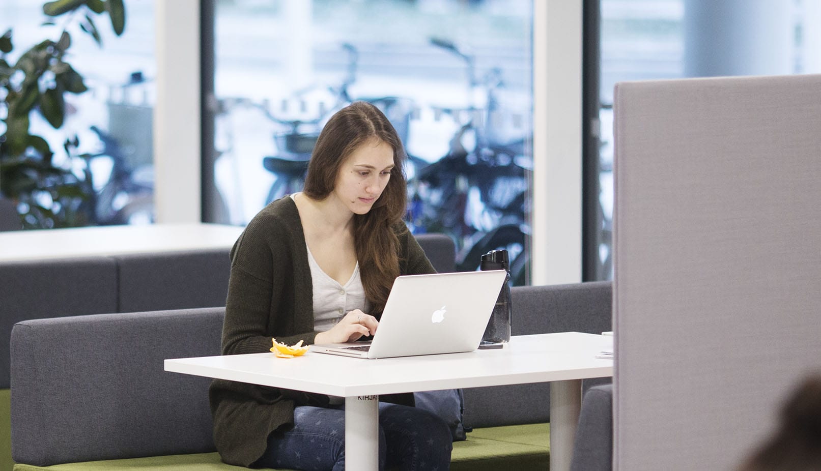 Woman student studying with laptop at SAMK-campus Pori library.