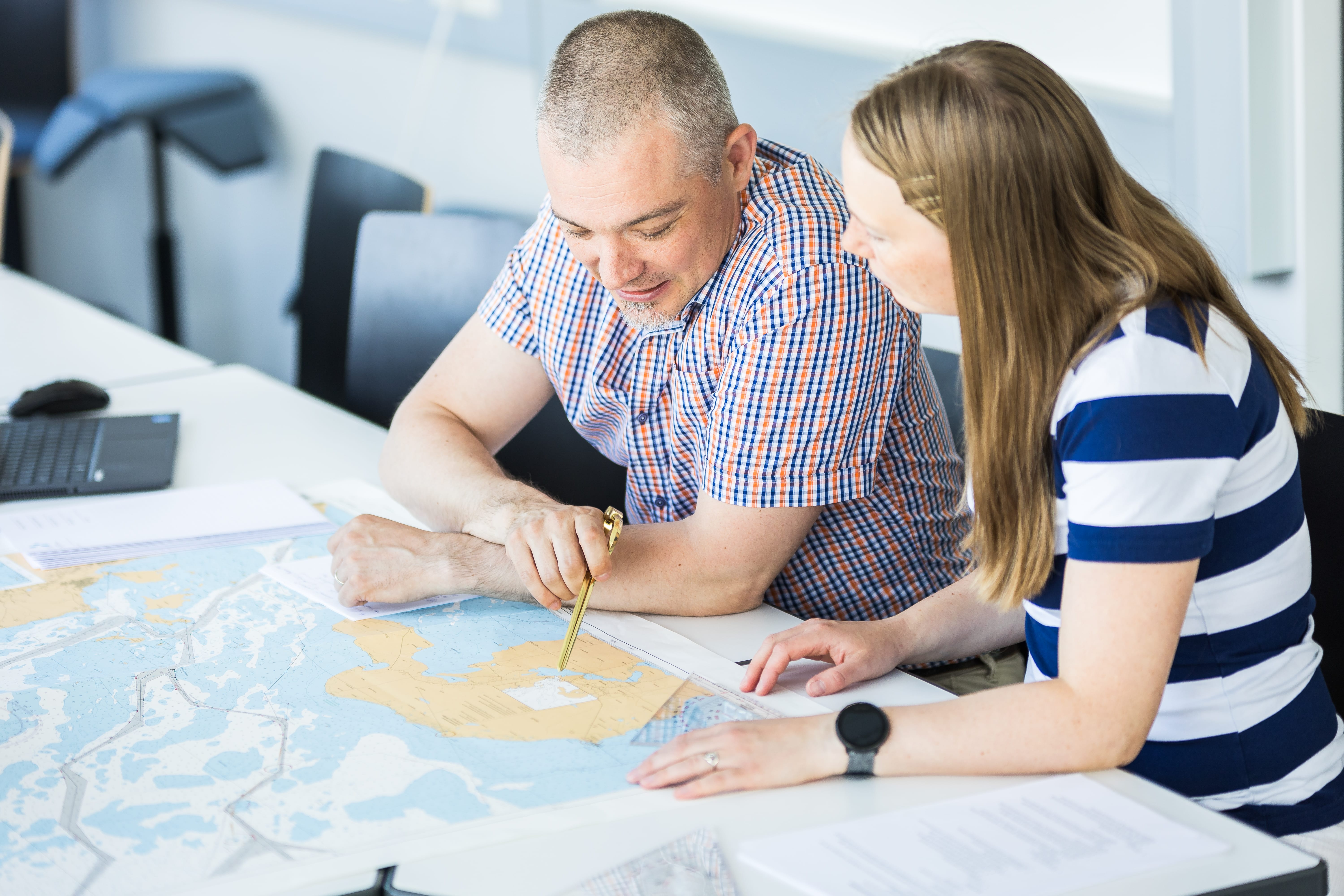 Man and a woman exploring a map.