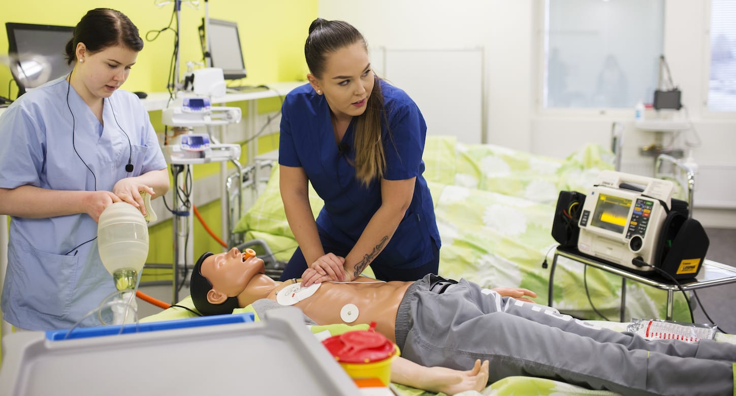 Students practice giving resuscitation with a doll