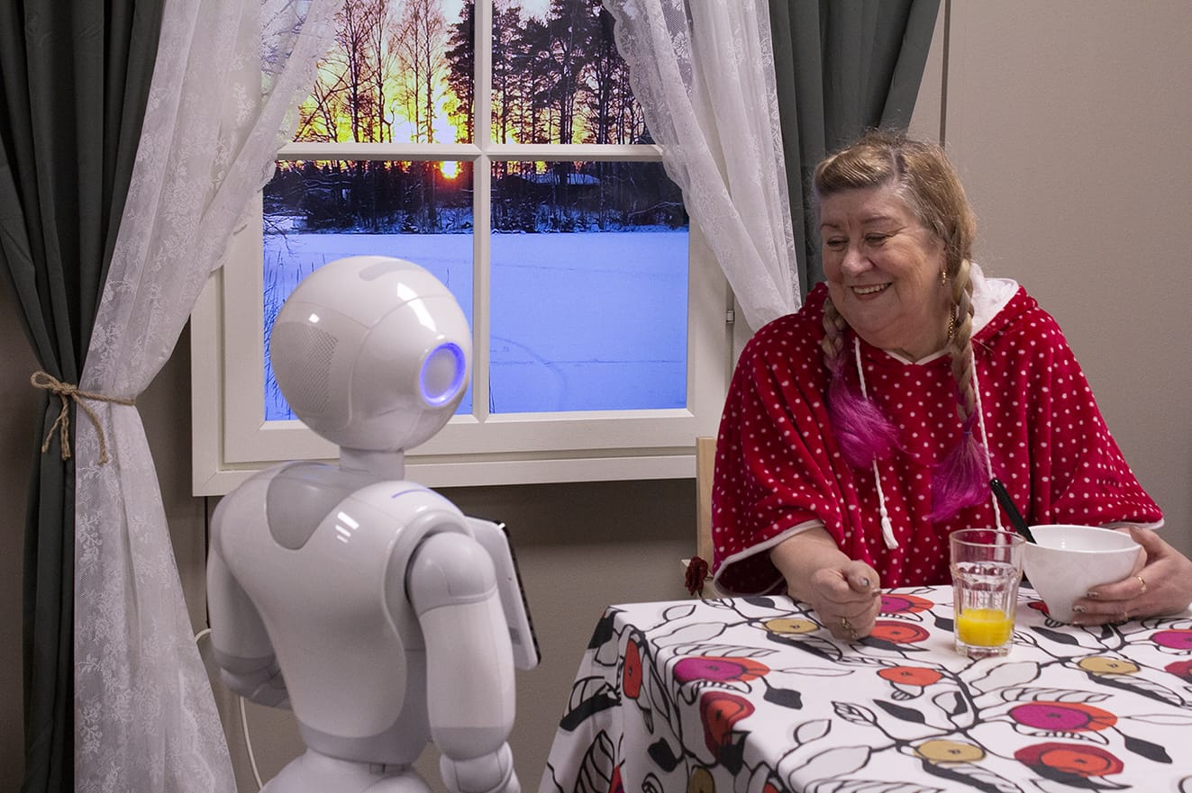 Pepper robot hanging out with senior.