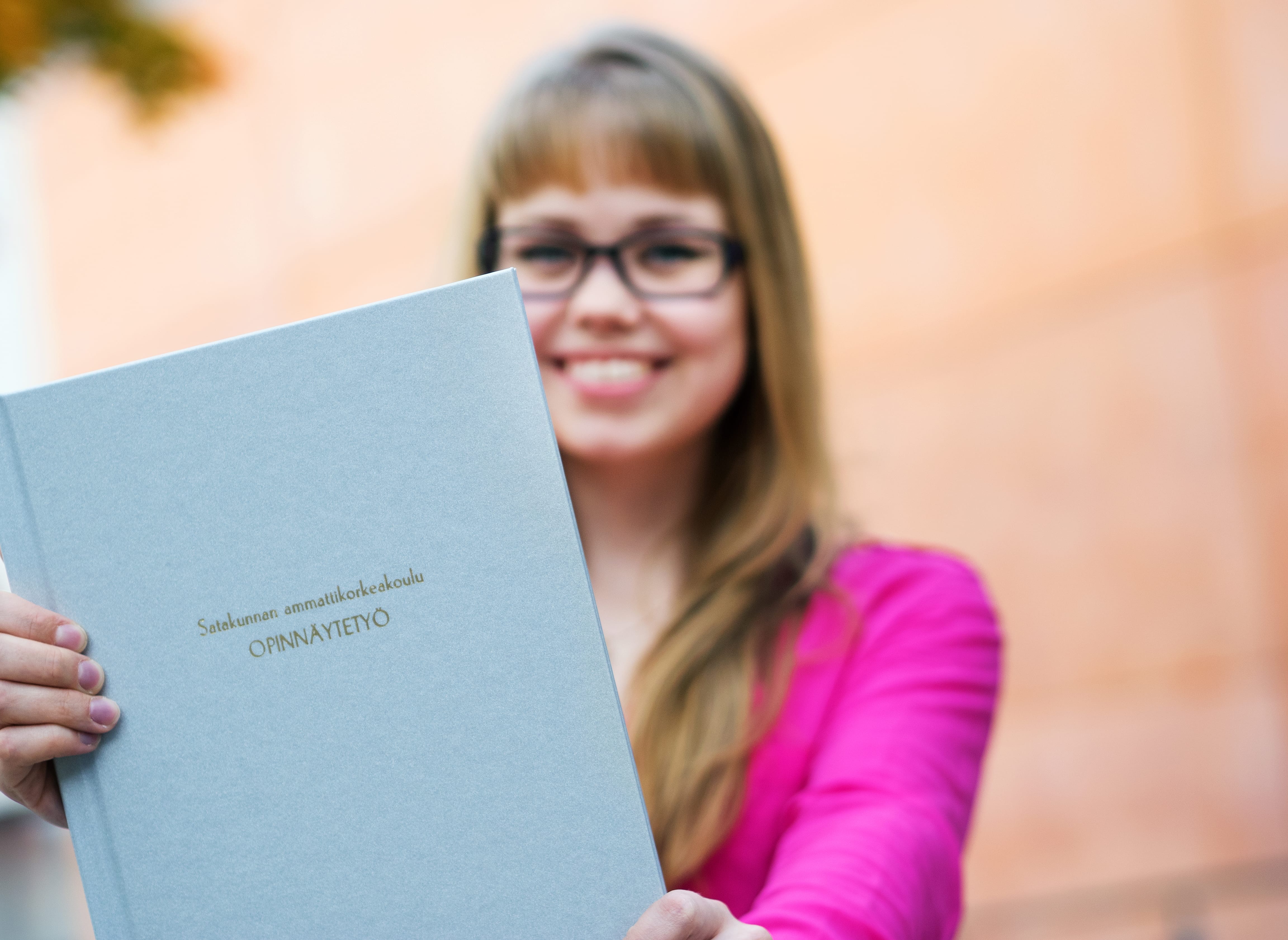 The person is holding the thesis.