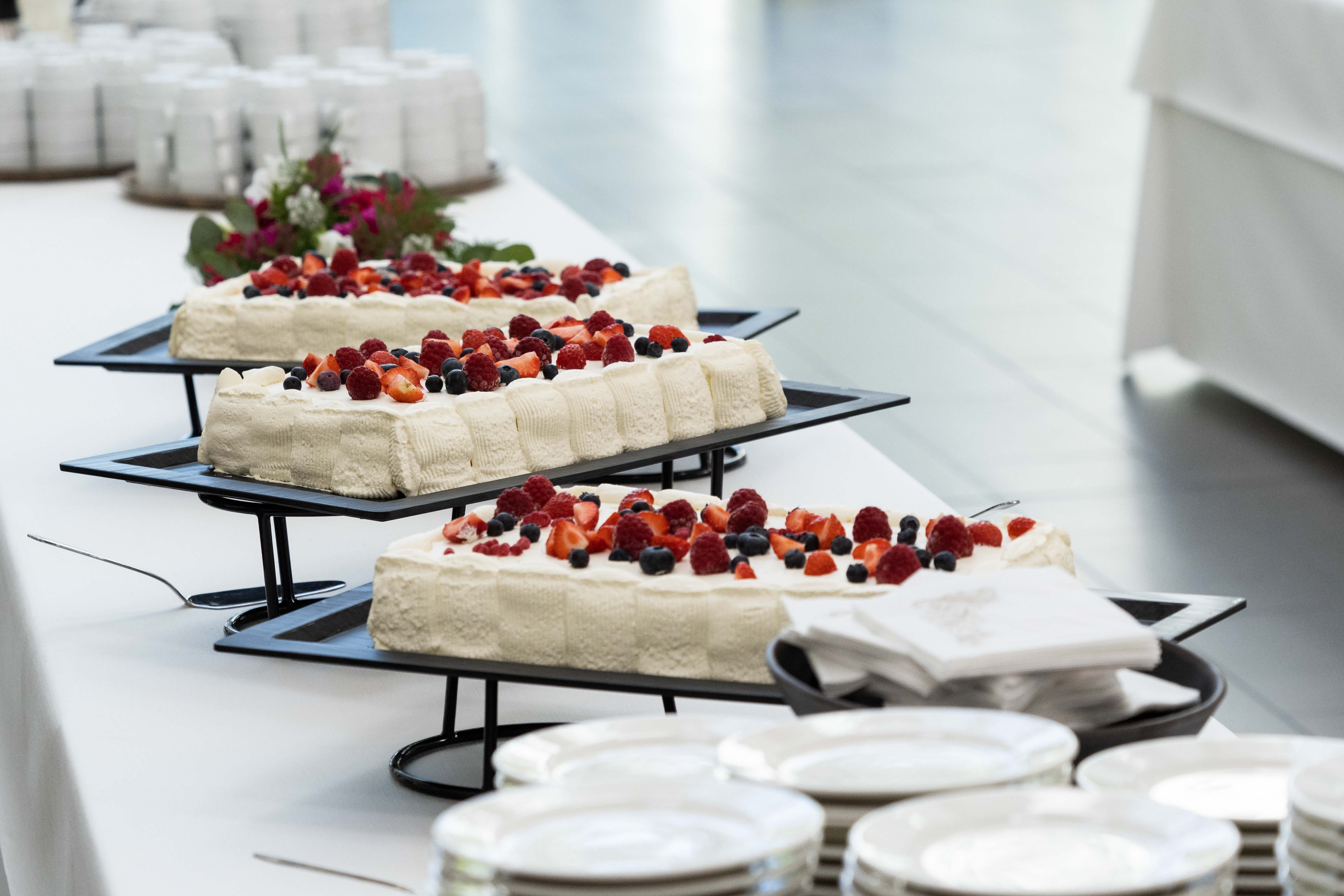 Berry-cream cakes on the serving table.